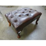 A chestnut brown leather Chesterfield footstool