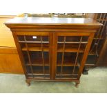 An Edward VII oak and astragal glazed two door bookcase