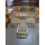 An Ercol Blonde beech four piece Windsor lounge suite, comprising a settee, pair of armchairs and