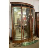 A large mahogany three door corner bow front shop cabinet, 240cms h, 177cms w, 39cms d