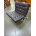 A Barcelona style black leather and chrome lounge chair