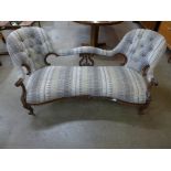 A Victorian walnut and fabric upholstered settee