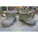 A pair of concrete boot shaped garden planters