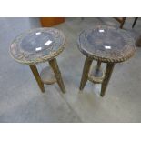 A pair of small Arts and Crafts Liberty & Co. carved wood circular occasional tables