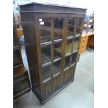 A carved oak linenfold two door bookcase