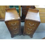 A pair of Edward VII oak three drawer pedestal chests