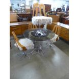 A 1970s chrome and smoked glass circular dining table and four Perspex chairs