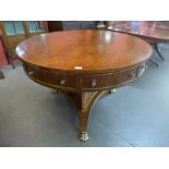 A Regency style simulated rosewood drum shaped four drawer library table