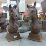 A pair of cast iron horses' head garden ornaments