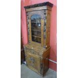 A 19th Century French carved oak green man bookcase