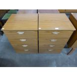 A pair of teak chests of drawers