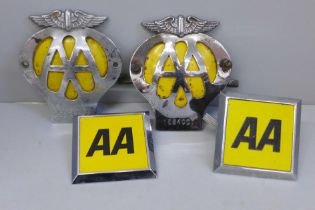A collection of four AA car badges