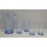 A blue glass lemonade set with etched design, four glasses and a jug, one glass a/f, chip to rim