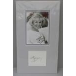 A Doris Day signed photo and signed page, (2)