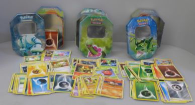 Three tins of Pokemon cards