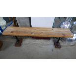 A pine and cast iron based bench