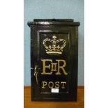 A black painted cast iron post box, with key