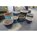 Eight terracotta garden plant pots