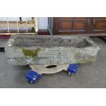 A rectangular sandstone garden trough