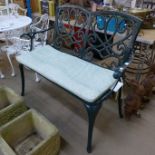 A painted wrought alloy garden bench