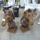 A pair of cast iron horse head garden ornaments