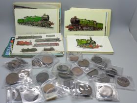 A collection of thirty coins and tokens including 19th Century and eighty-five locomotives postcards