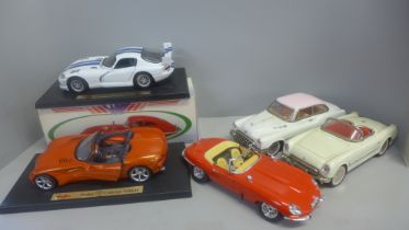 A collection of vintage model 1/18 scale cars with two E-Type Jaguars and Dodge Concept Vehicle