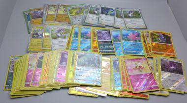 100 reverse holo and holo Pokemon cards, some in protective sleeves