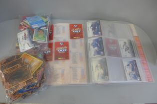 A collection of Konami Yu-Gi-Oh! cards, a Shoot Out Premier League trading card folder, partially