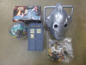 A Star Wars Episode 1 Flash Speeder, a Doctor Who Cyberman helmet, a Tardis with trading cards,
