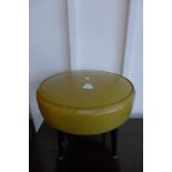 A mustard vinyl stool