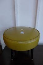 A mustard vinyl stool