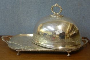 A plated meat dome, a serving tray and a cake slice