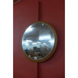 A circular teak framed mirror