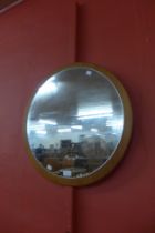 A circular teak framed mirror
