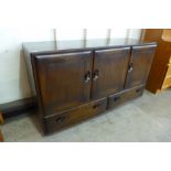 An Ercol Golden Dawn elm Windsor sideboard