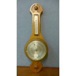 A carved walnut aneroid barometer