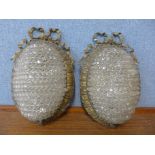 A pair of French rococo style gilt metal and glass wall lights