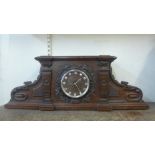 A late 19th Century French carved oak architectural cased mantel clock