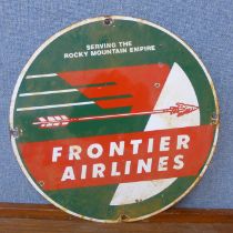 An enamelled circular Frontier Airlines advertising sign