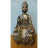 An oriental faux bronze figure of a seated deity