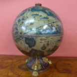 A table top terrestrial globe cocktail cabinet