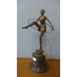 An Art Deco style bronze figure of a dancing hoop girl, on rouge marble socle