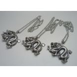 Three large dragon pendants on chains