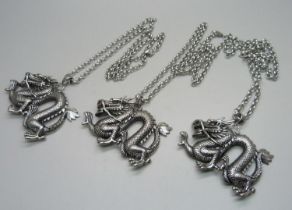 Three large dragon pendants on chains