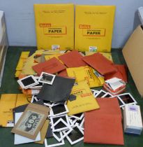 A collection of vintage photographic negatives and photographic paper
