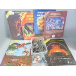 A collection of metal Dungeons and Dragons figures, rules books and Dragon Masters guides