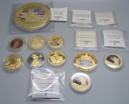A collection of gold plated coins including Kings and Queens, Winston Churchill, St. George and