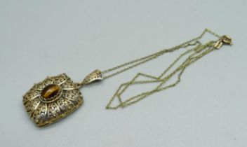 An 835 silver gilt filigree pendant set with tigers eye marked MN, on a chain