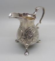 A George II silver cream jug, London 1744, with pigeon and other bird detail, 101g